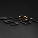 Talon kirjain Koti - Musta